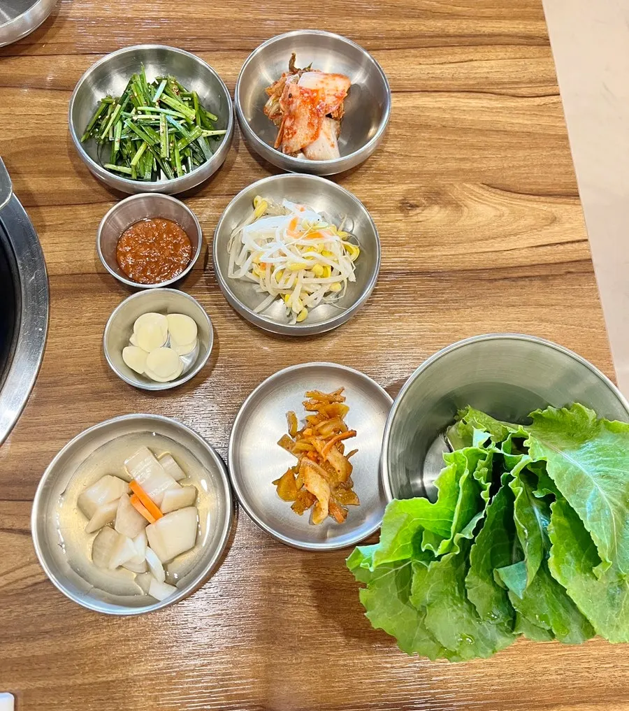 Bean sprout salad and ssam vegetables served as side dishes