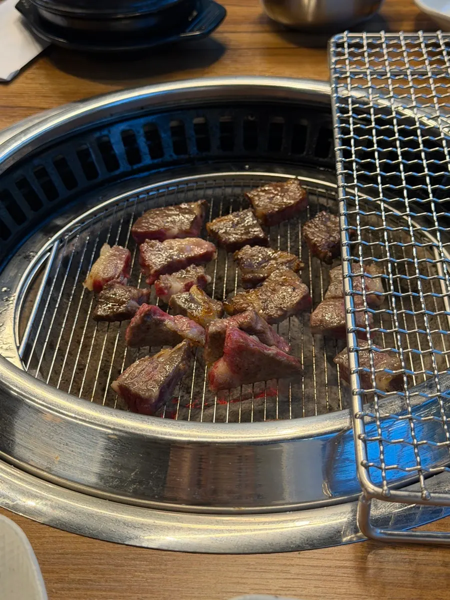 Beef raw short ribs grilling on the tabletop grill