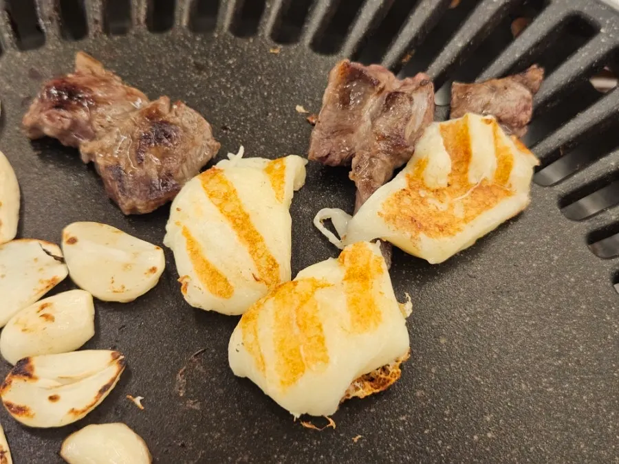 Grilled cheese placed on the grill plate