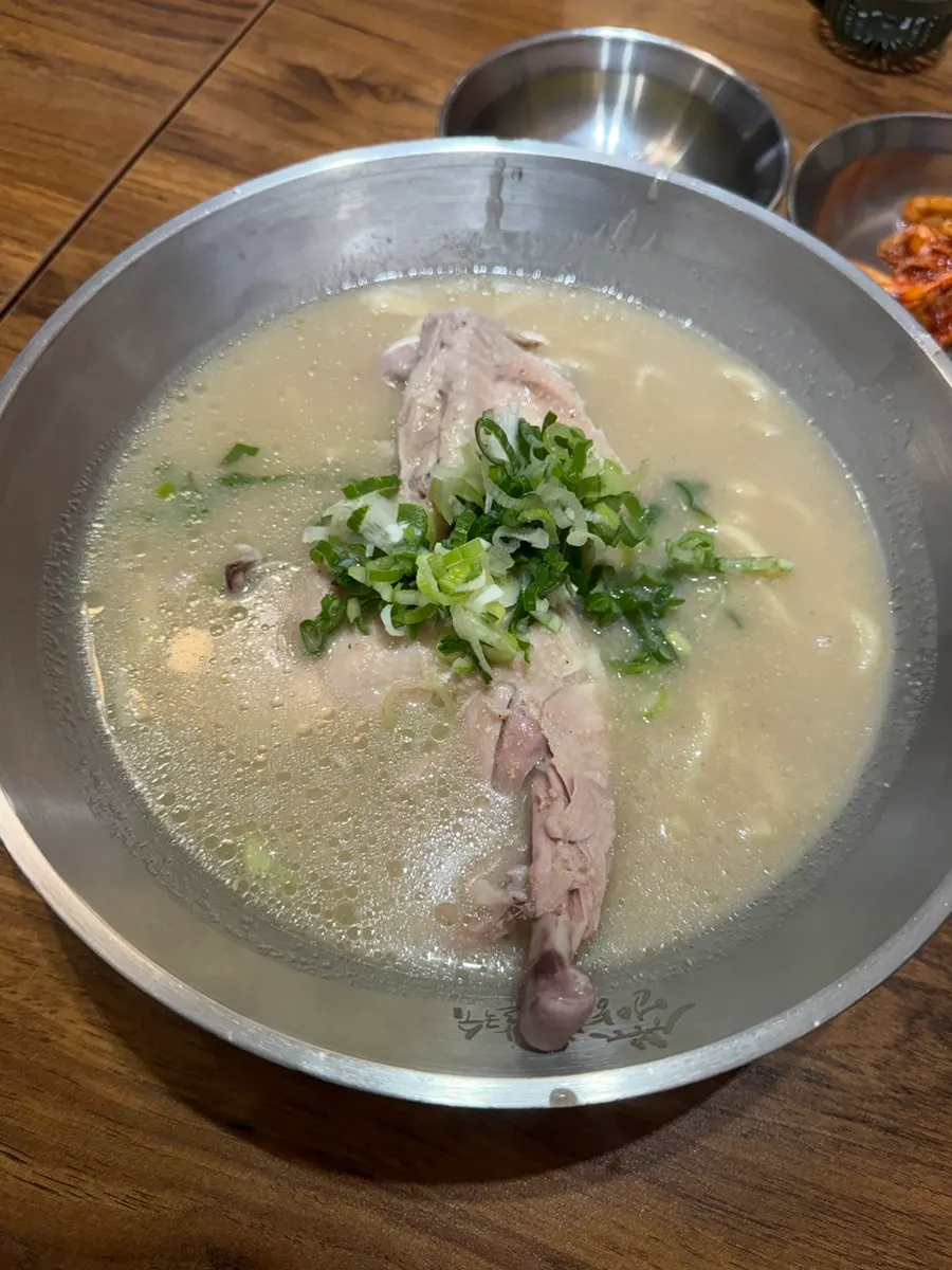 Two bowls of dak kalguksu set on the table