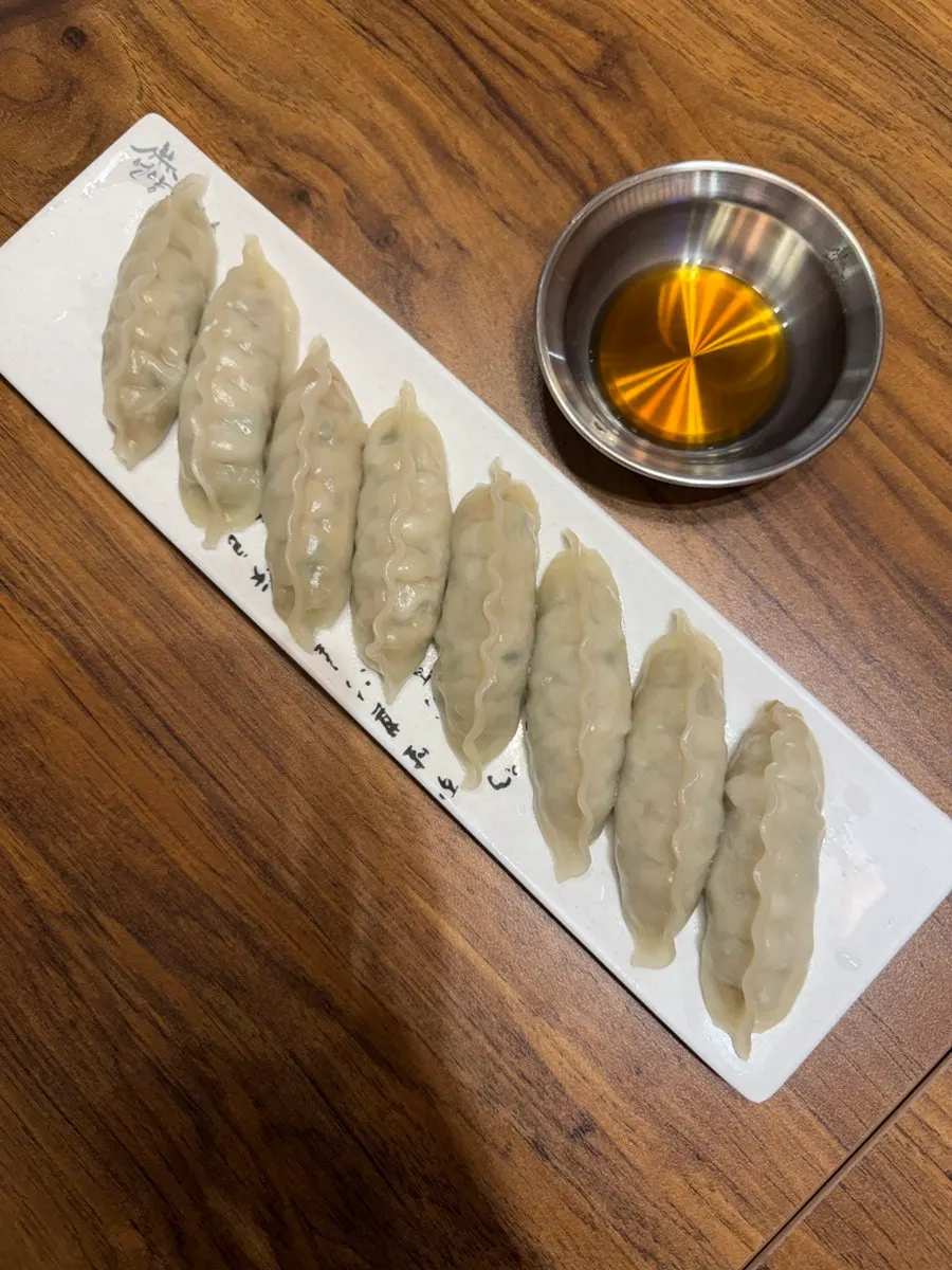 A bite of noodles with silbi kimchi