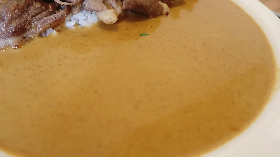 A bowl of cream curry served with rice