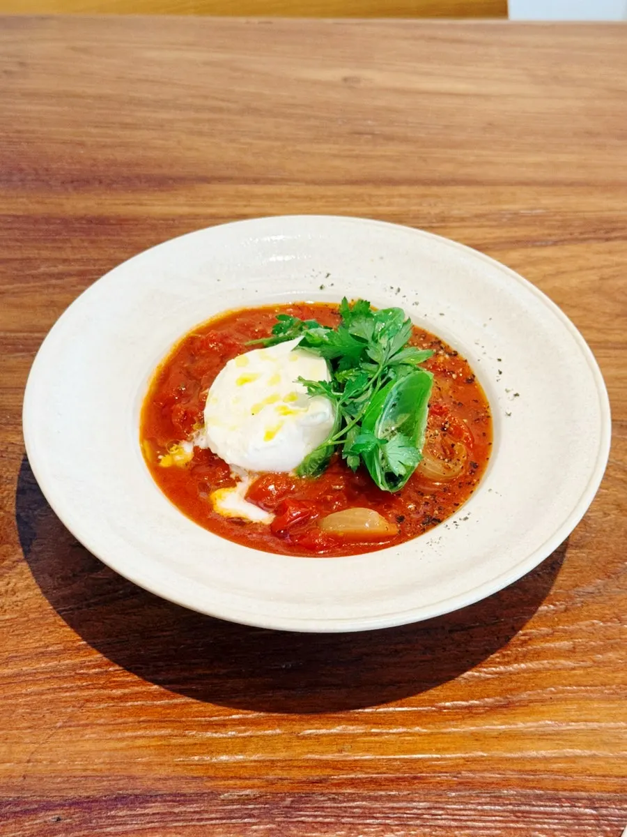 Tomato stew topped with burrata