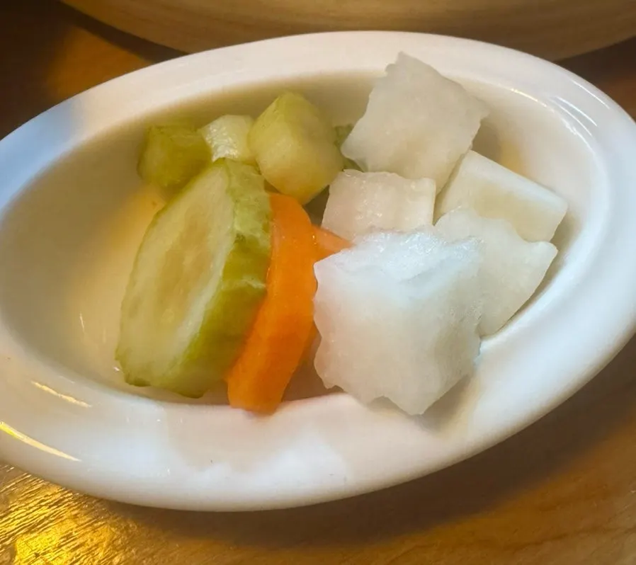 Side dishes of radish and cucumber pickles