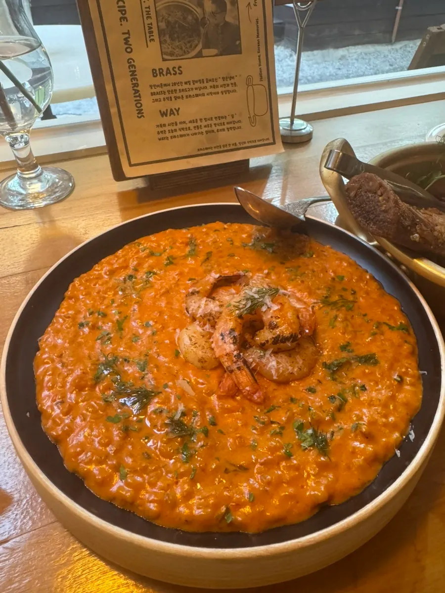 Shrimp tomato rosé risotto topped with whole shrimp