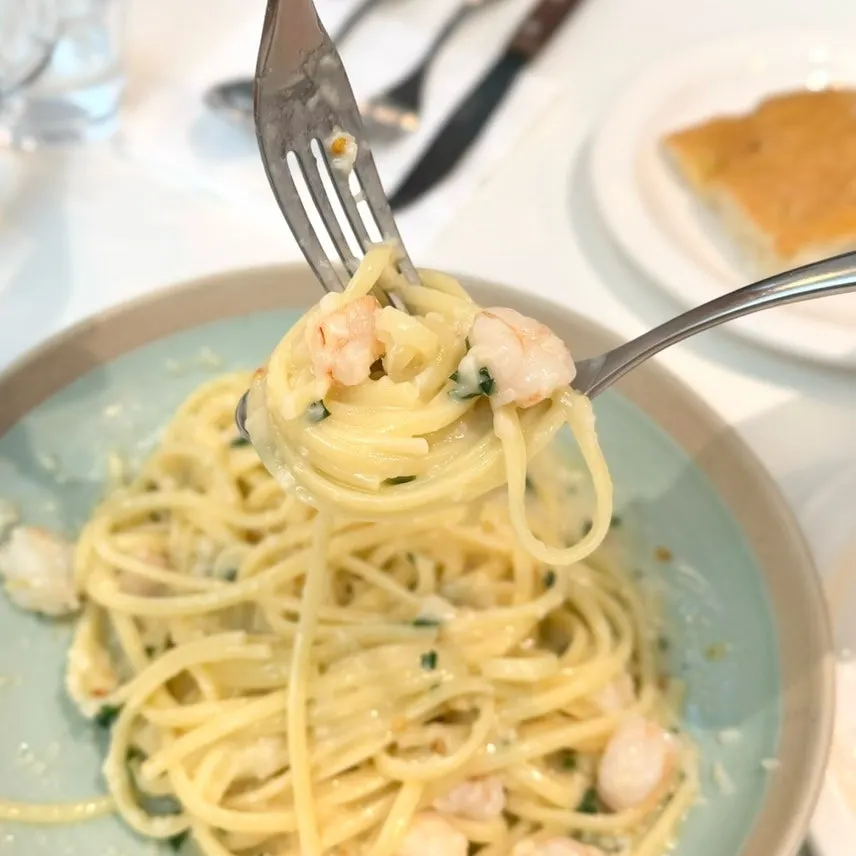 Aglio olio noodles twirled on a fork