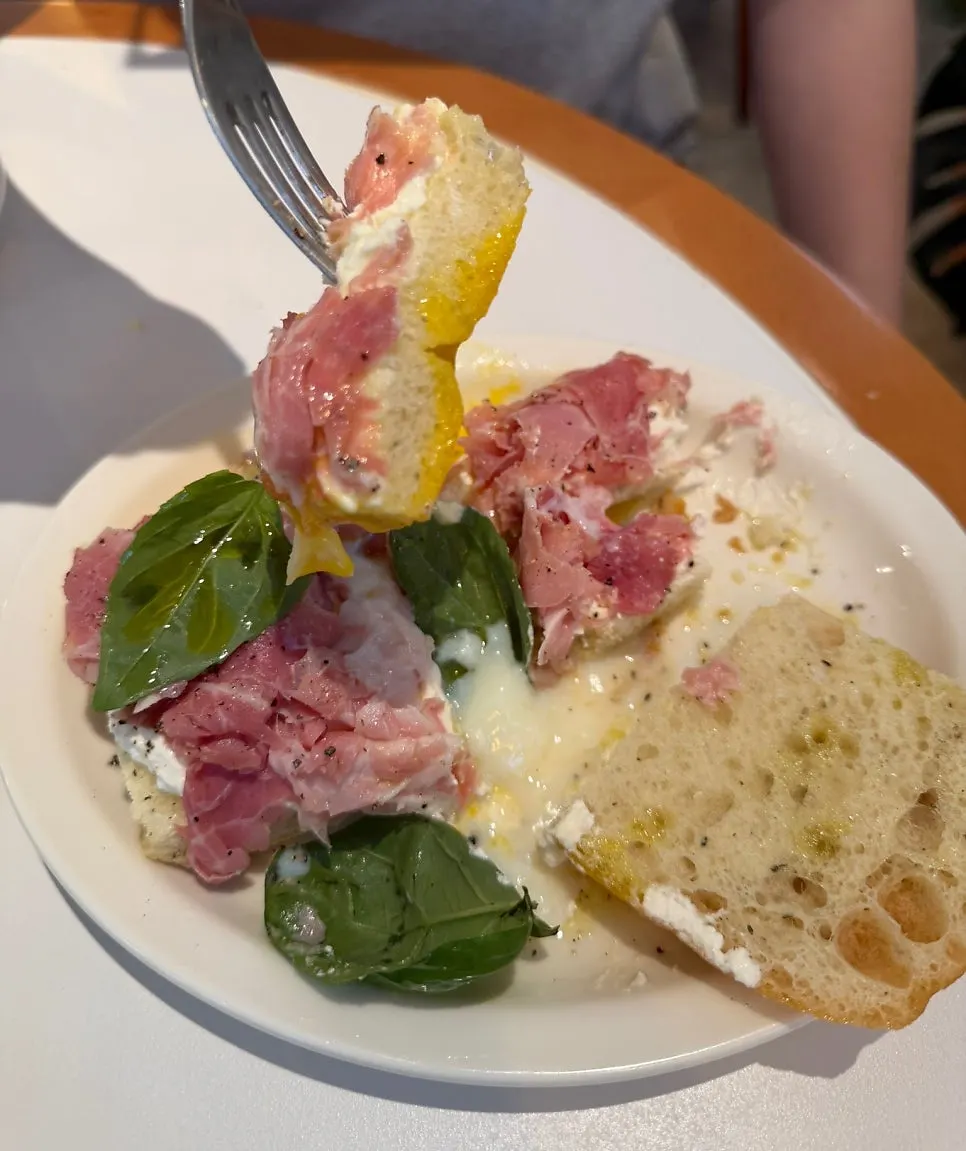 A bite of the ricotta cheese sandwich