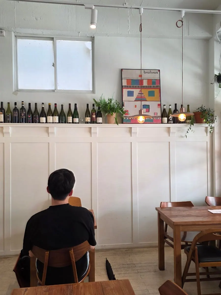 A corner of the restaurant lined with wine bottles