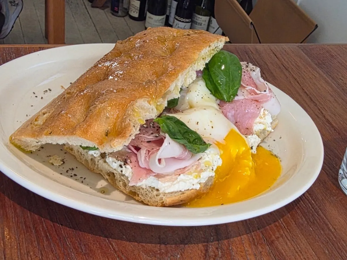 Table setting with bottarga pasta and focaccia sandwich