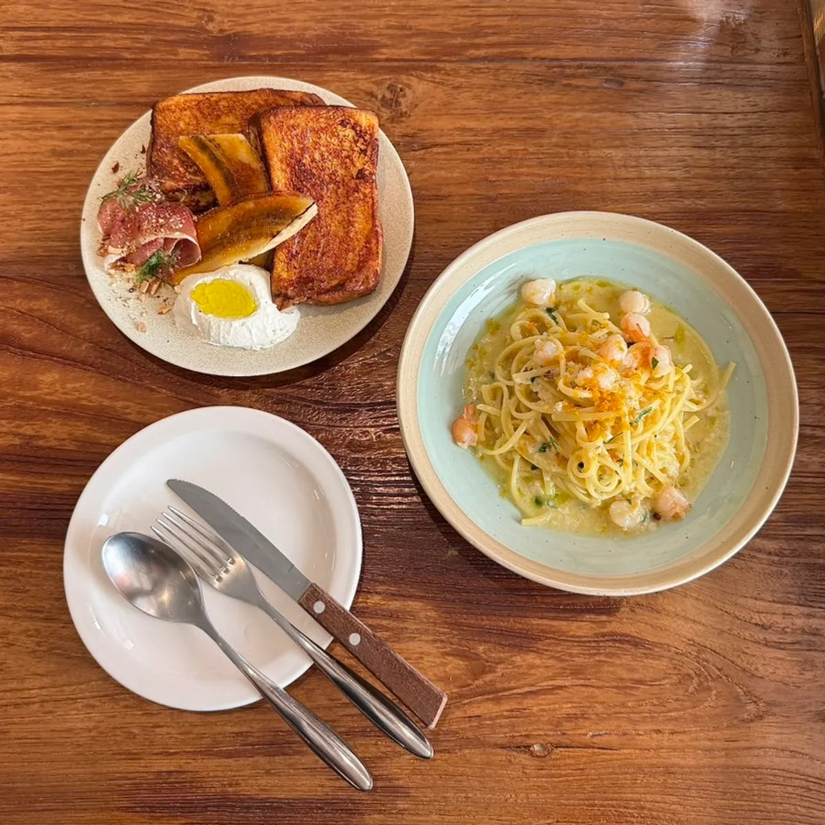 Jamón French toast and bottarga aglio olio served on the table