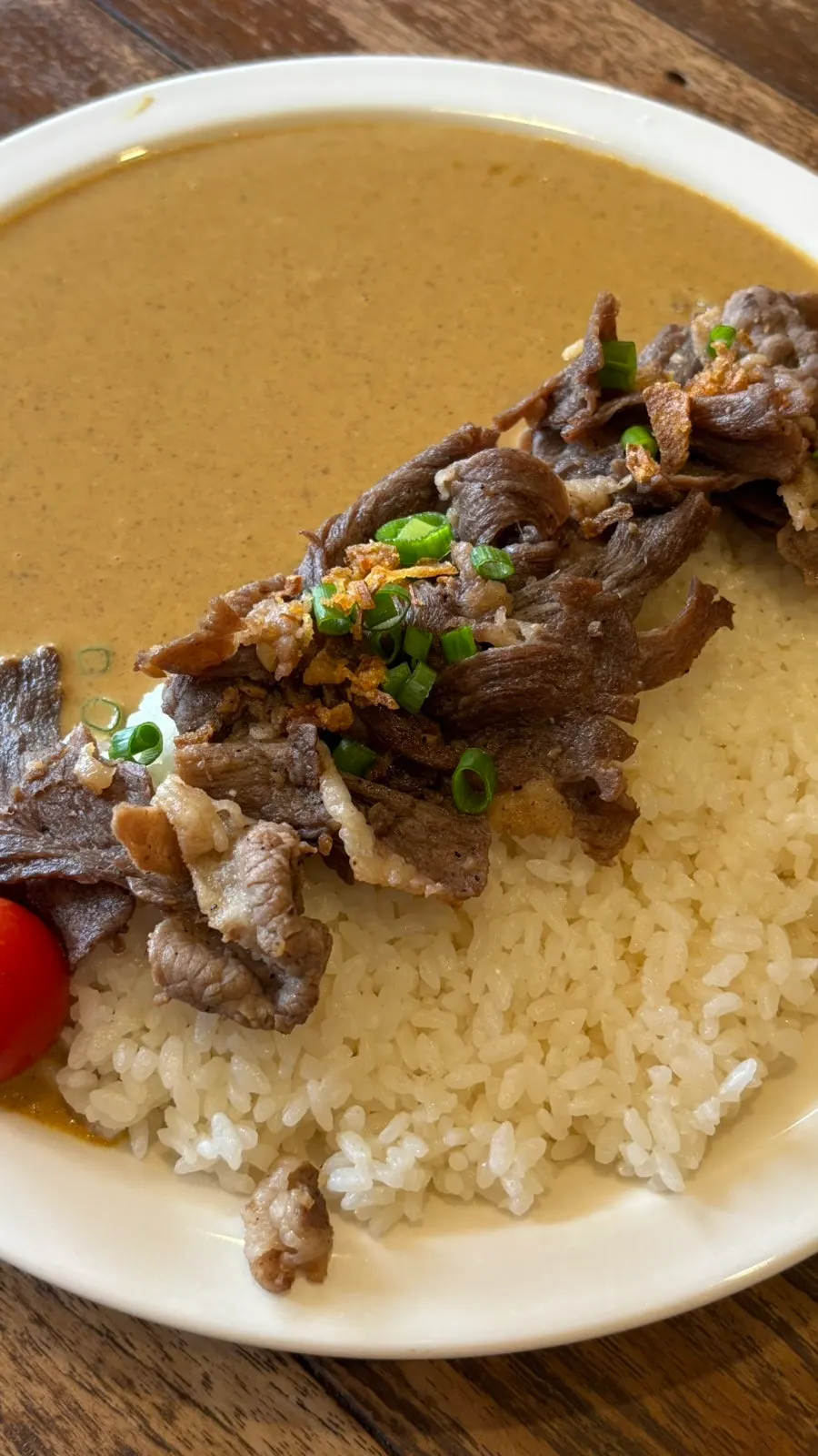 Brisket and cream curry scooped up together with rice