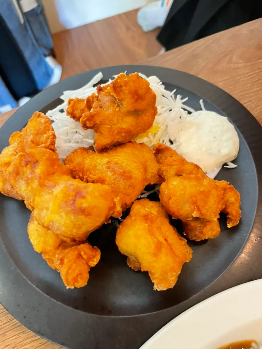 Poached egg broken and mixed into the special curry