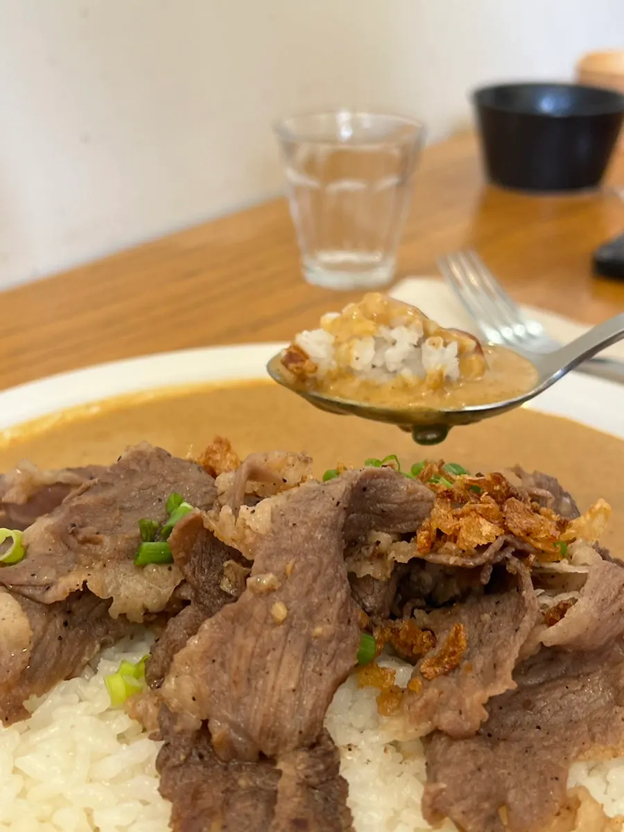 A piece of beef brisket picked up with chopsticks