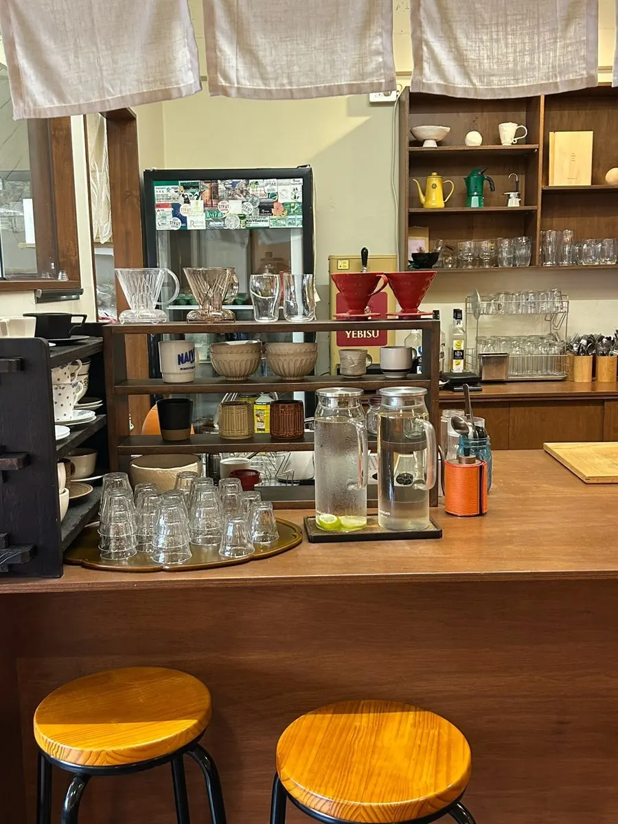 Service table with water cups, lime water, and green tea