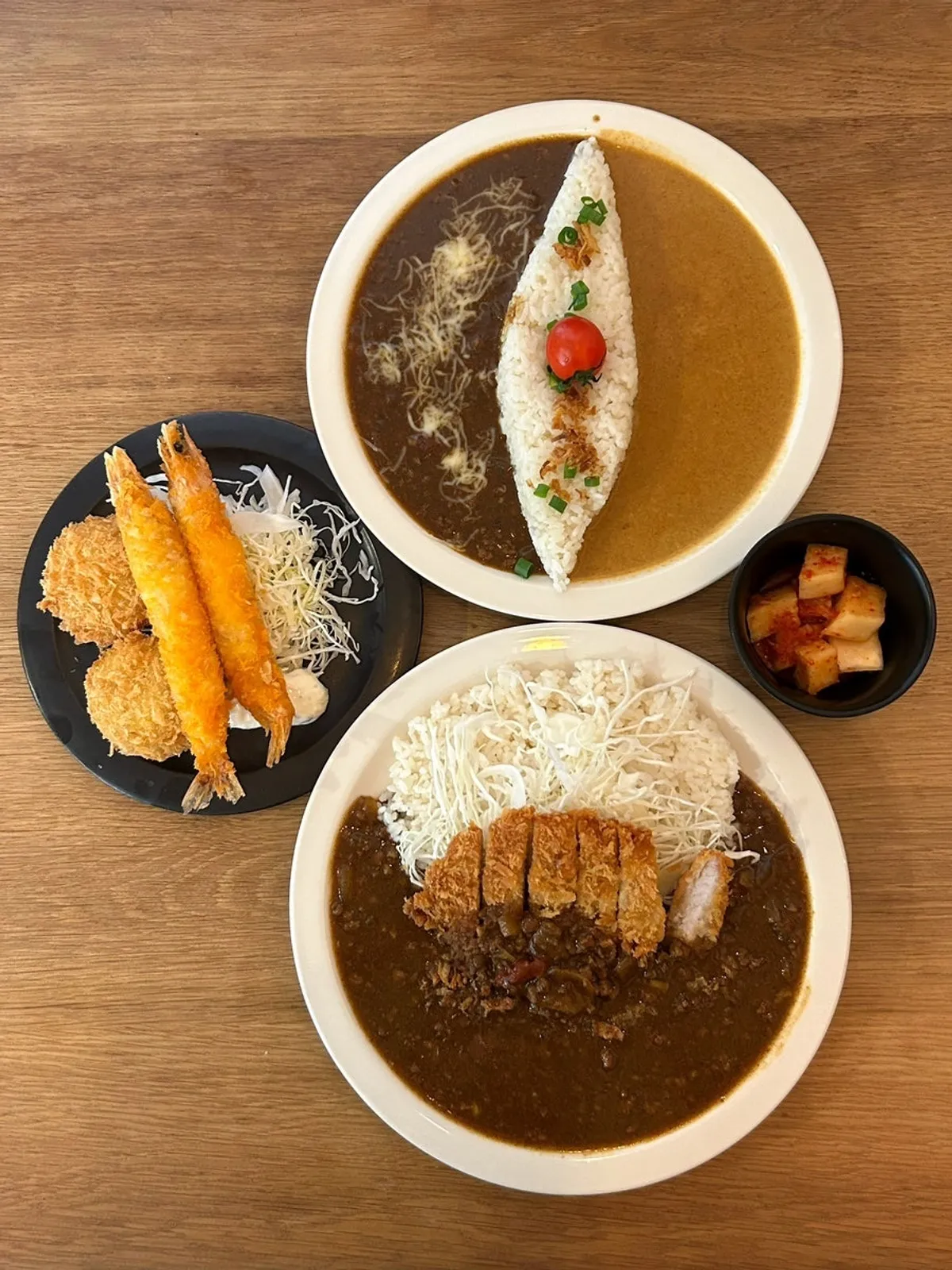 Curry and side dishes served at the table at Sarugak20