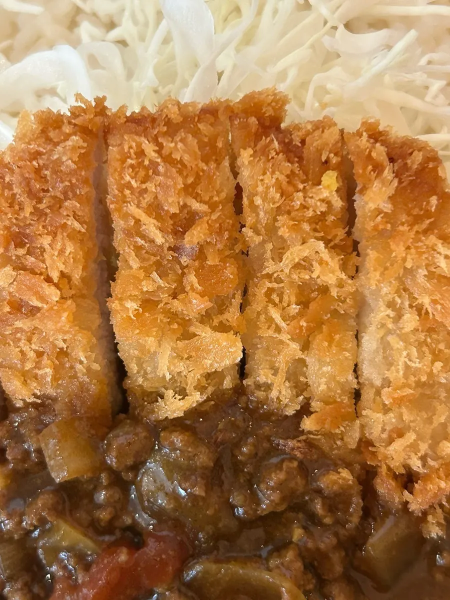 Cross-section of crispy tonkatsu and shredded cabbage