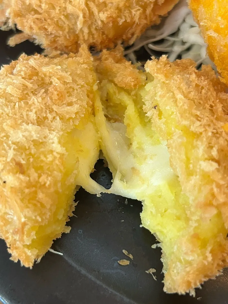 Cross-section of croquette filled with cheese and sweet potato