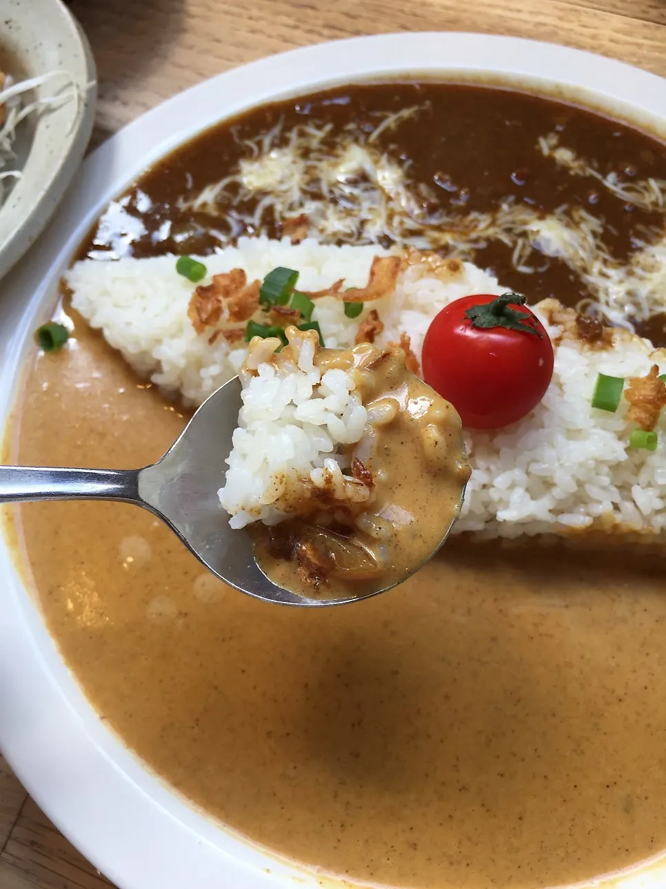 Close-up of the cheese-topped special curry portion
