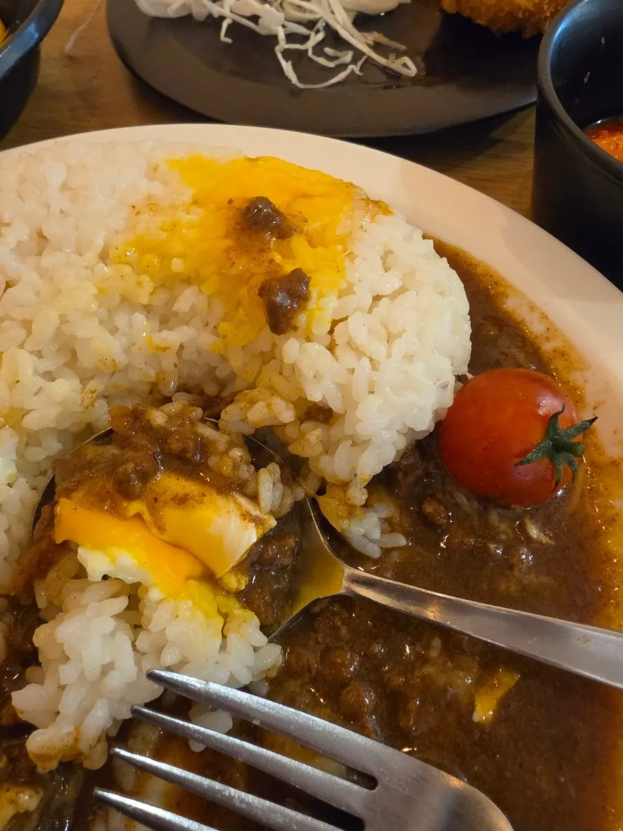Fried egg yolk placed on top of the curry