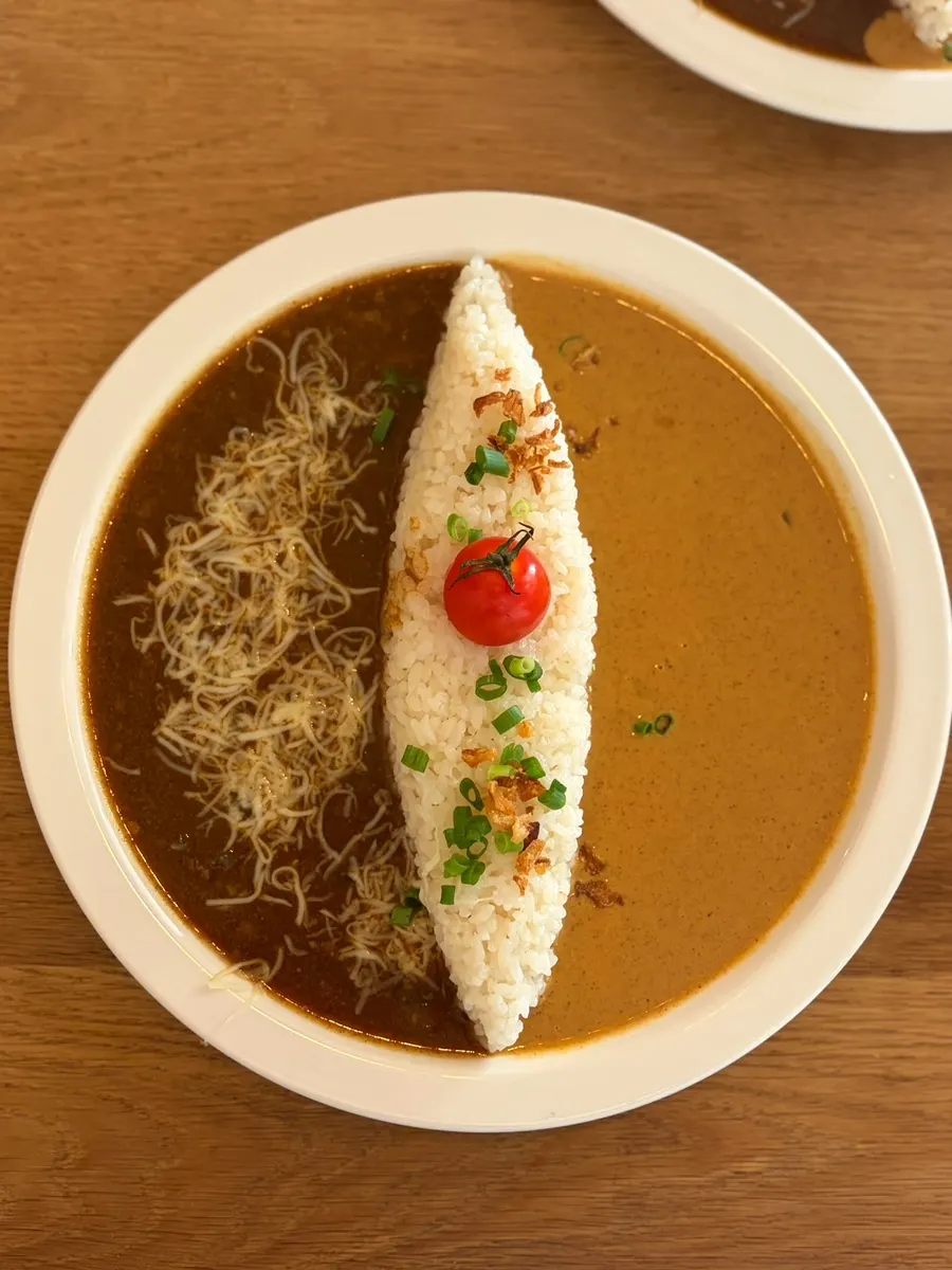 Half-and-half curry plating topped with a cherry tomato
