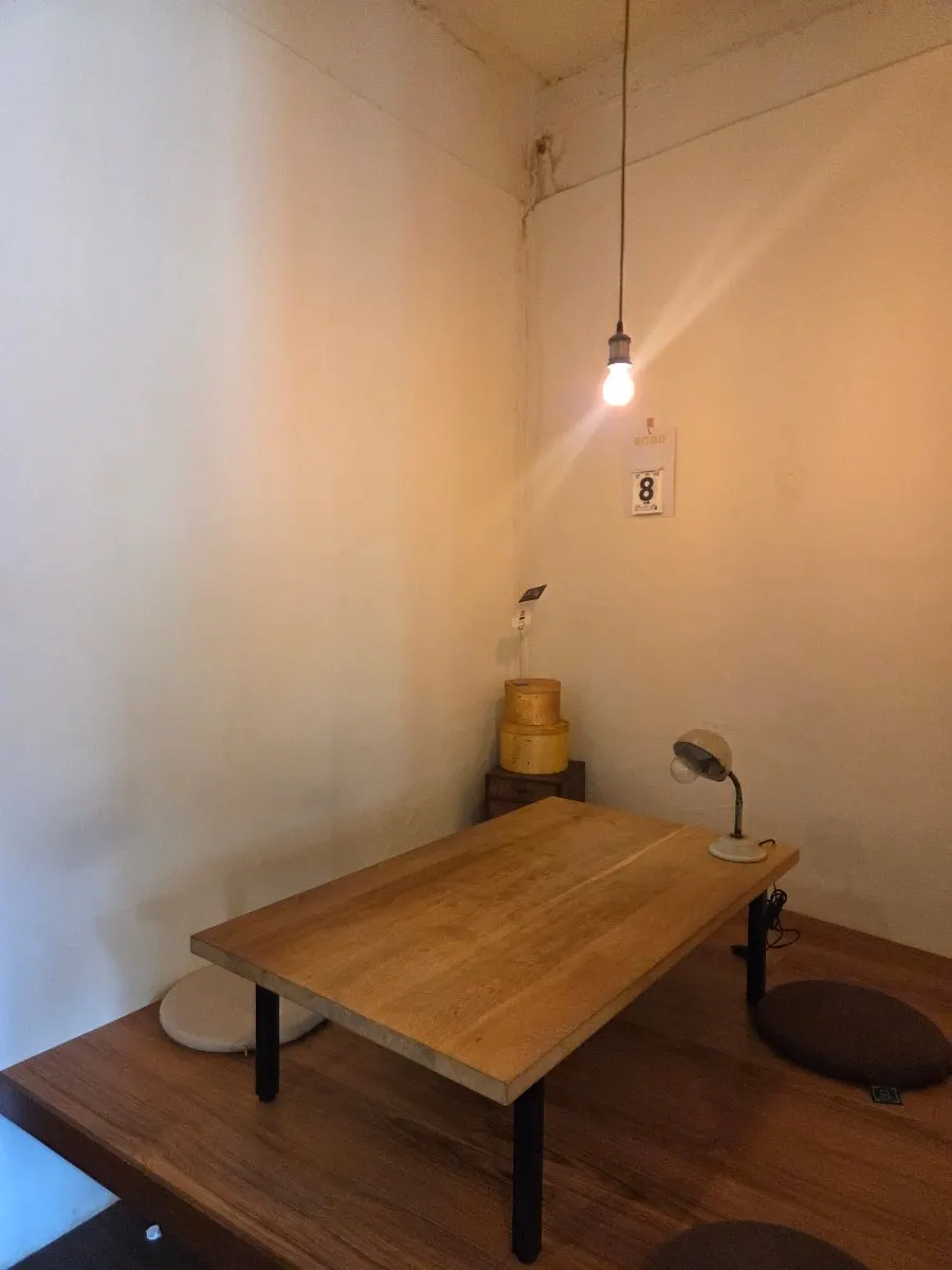 Floor seating area with a small table and single light