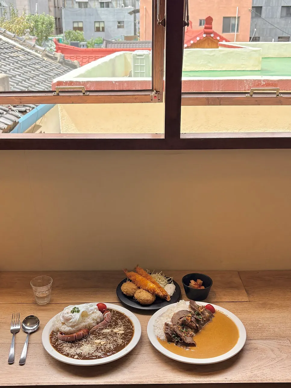 A full spread of curry and side dishes served together