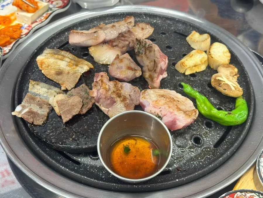Rare cuts grilling on the pan with bubbling myeoljeot sauce