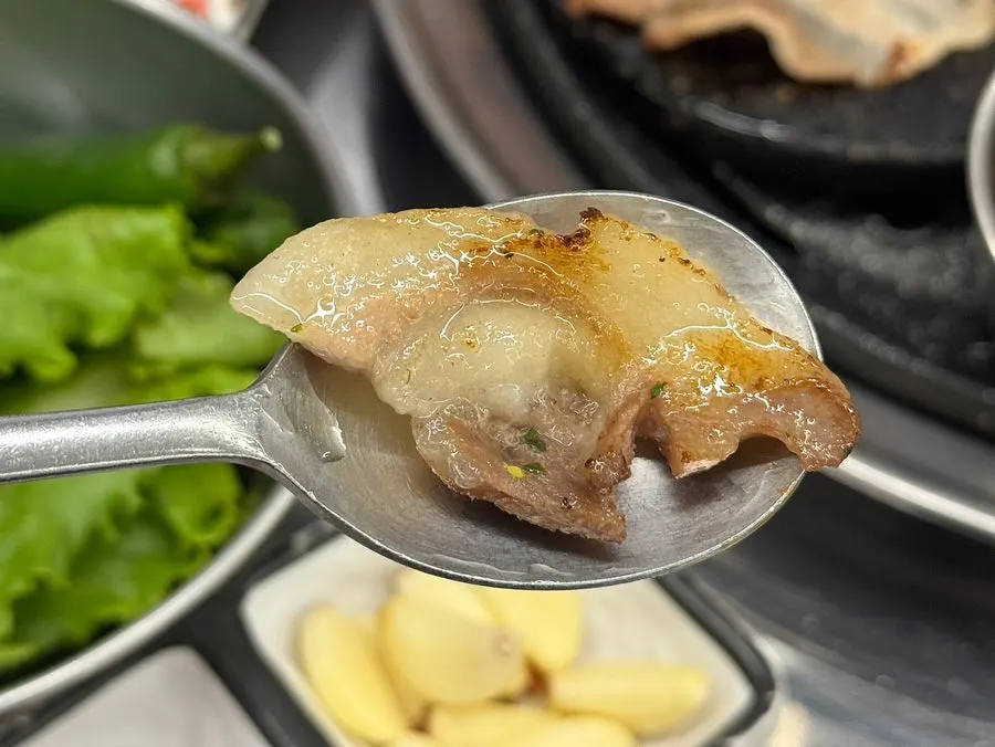 Rare pork cuts turning golden brown on the grill