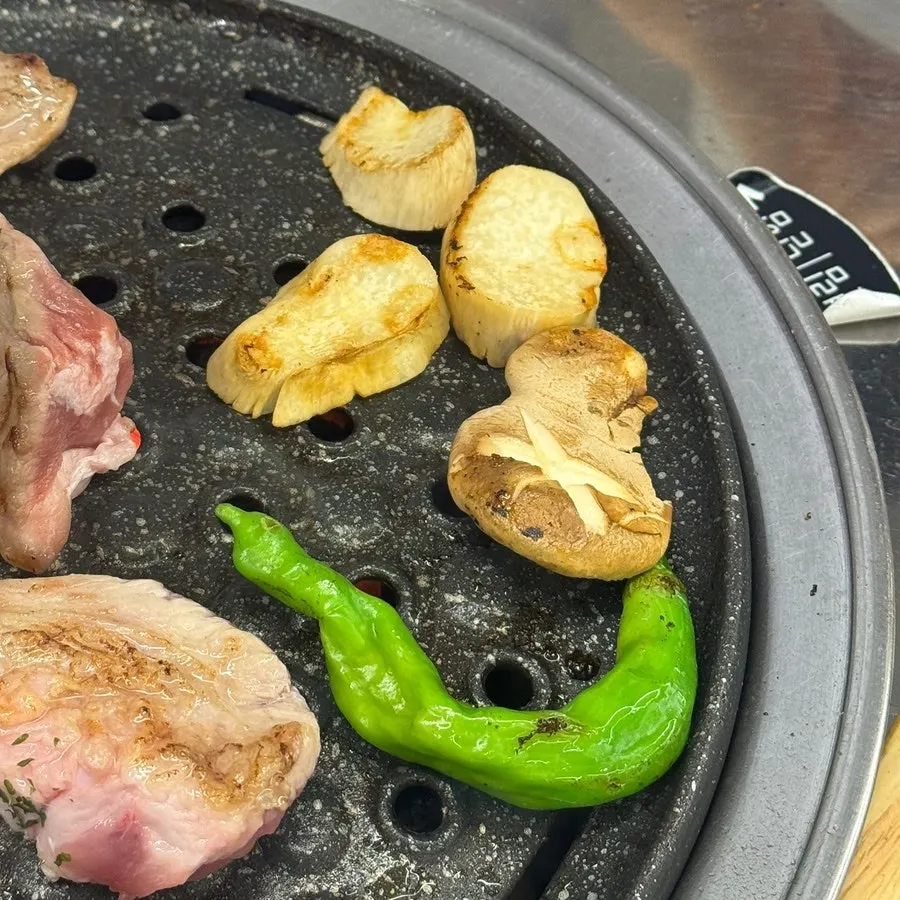 A piece of grilled meat with bibim guksu