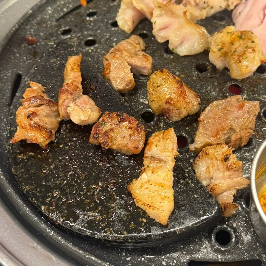 A piece of rare cut dipped in spicy sauce