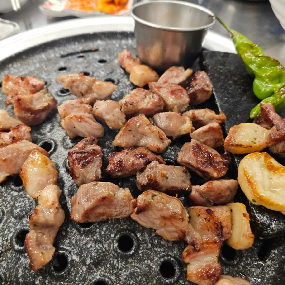 Thick dwitgogi cuts grilling over charcoal