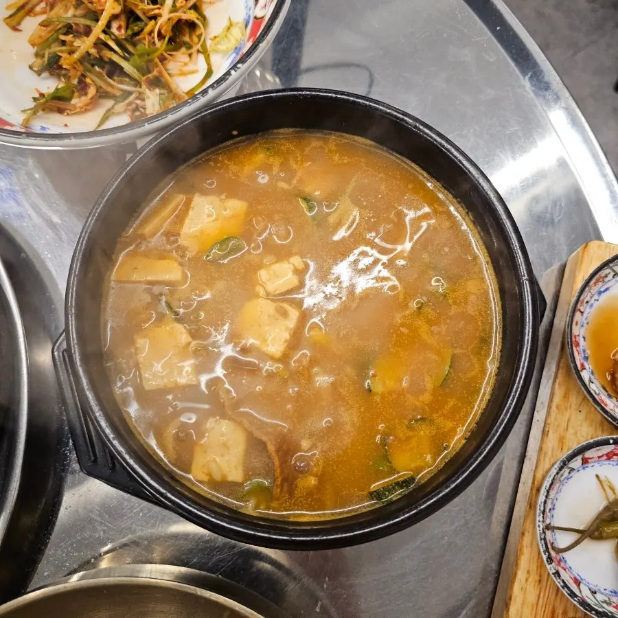 Doenjang sulbap and other dishes arriving alongside the meat