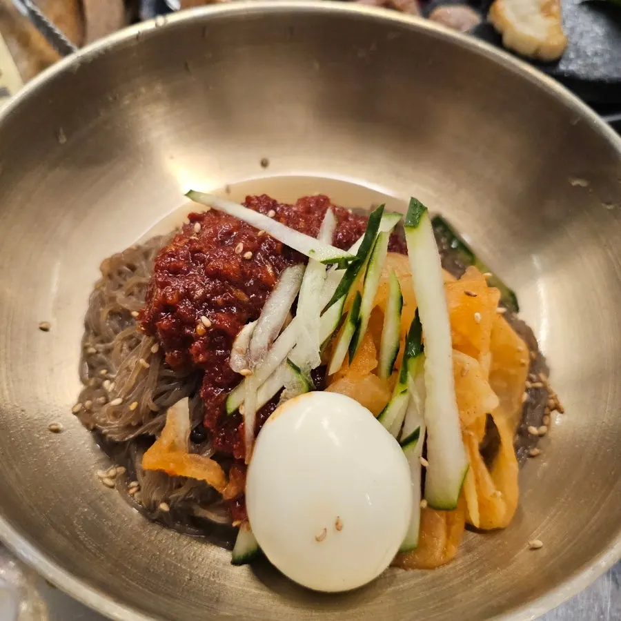 Table set with beer, dwitgogi, and doenjang sulbap