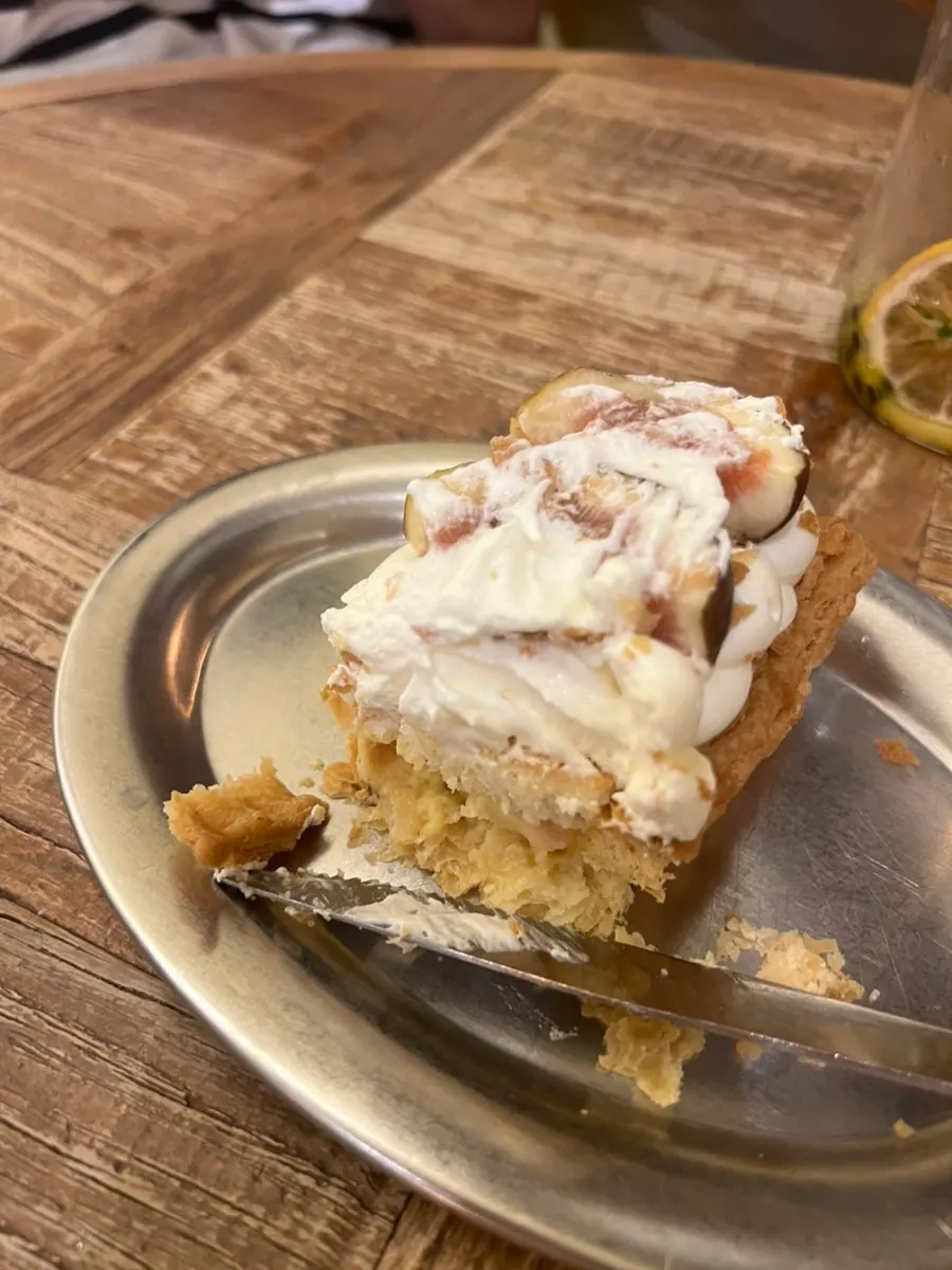 Pie topped with fresh cream and fresh figs