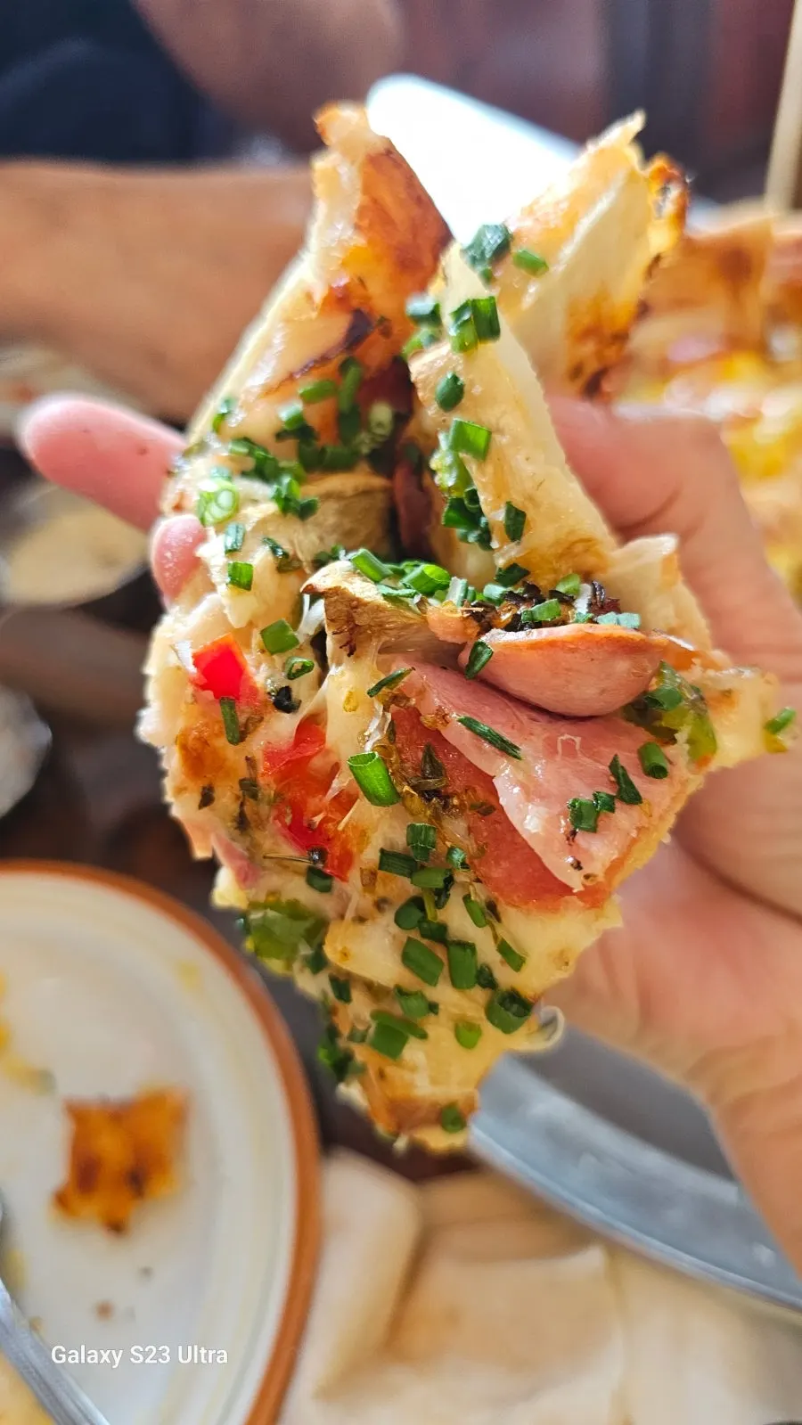 A generously topped slice of Freewill pizza