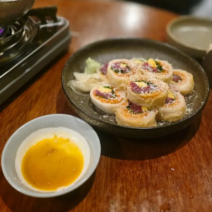 Raw beef and aged kimchi roll neatly plated
