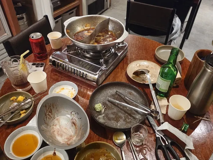 Emptied hotpot and plates on the table