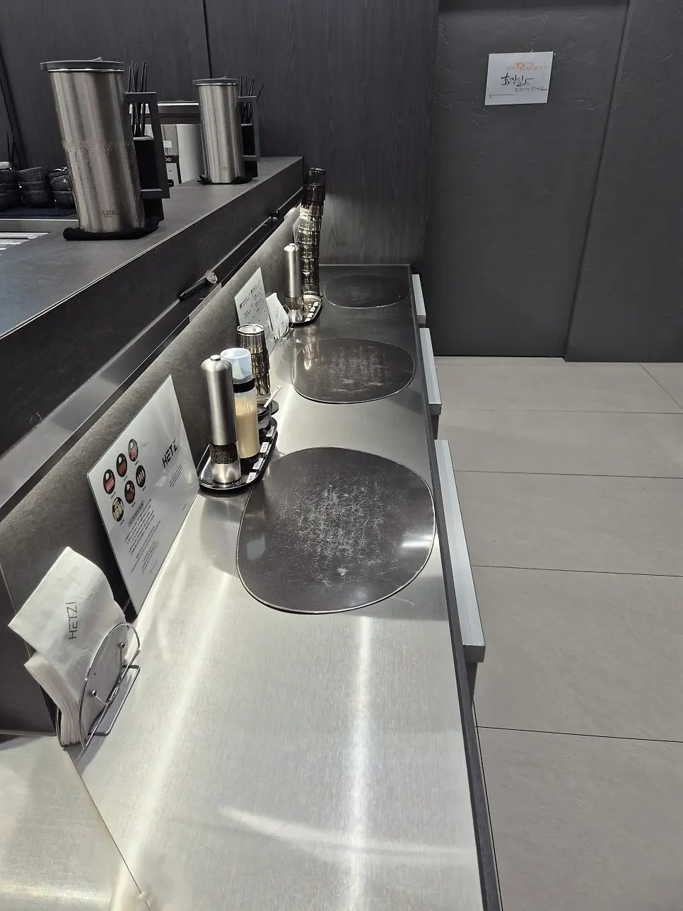 Stainless steel, black, and gray restaurant interior