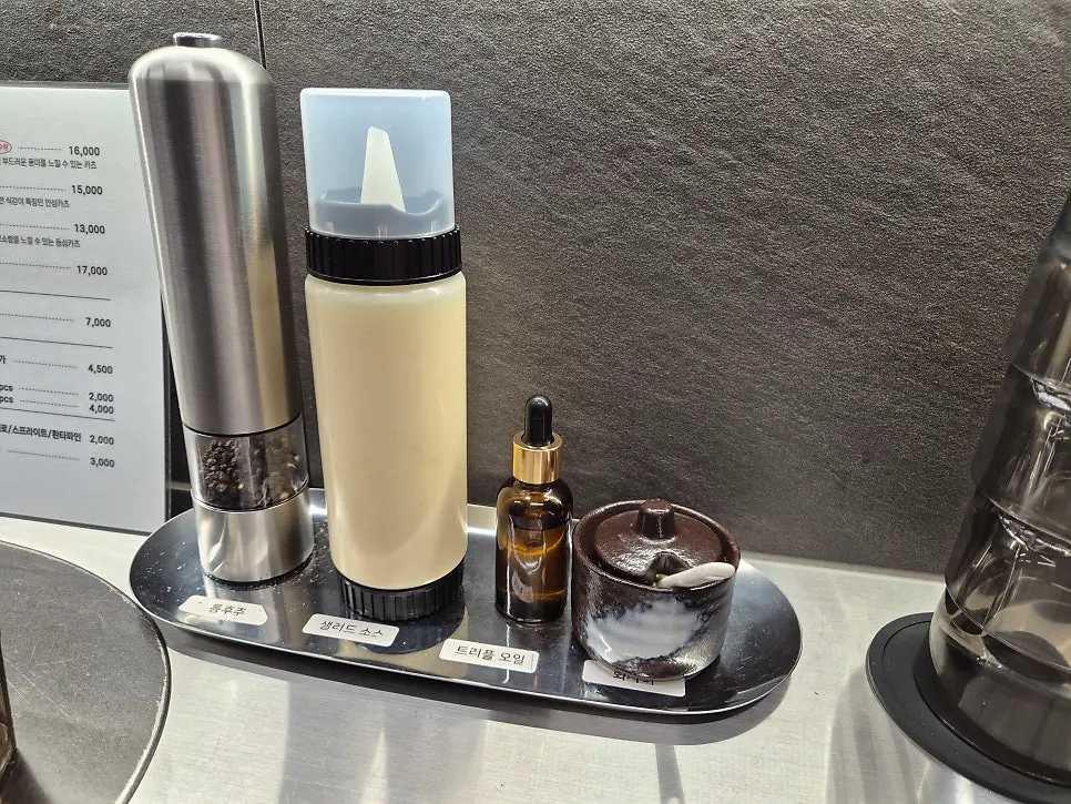 Pepper grinder, truffle oil, and wasabi set on the table