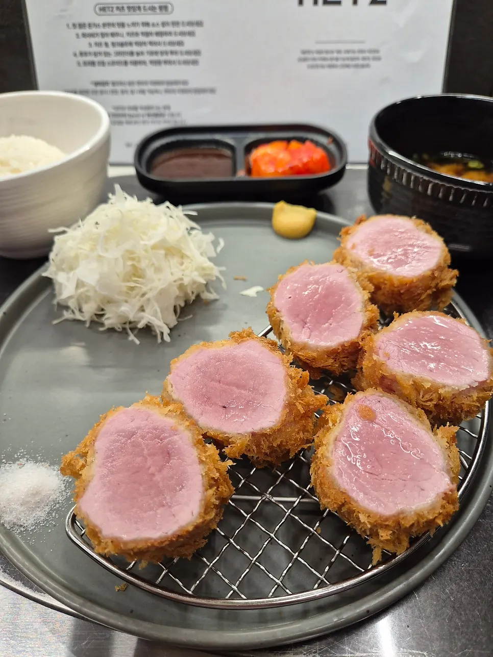 Cross-section of hire katsu dipped in tonkatsu sauce