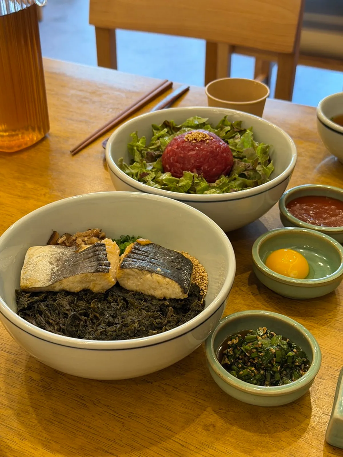 Full table setting with mackerel thistle rice and yukhoe bibimbap
