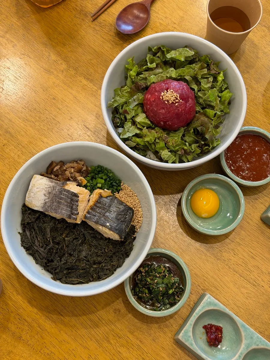 Overhead shot of mackerel thistle rice and yukhoe bibimbap