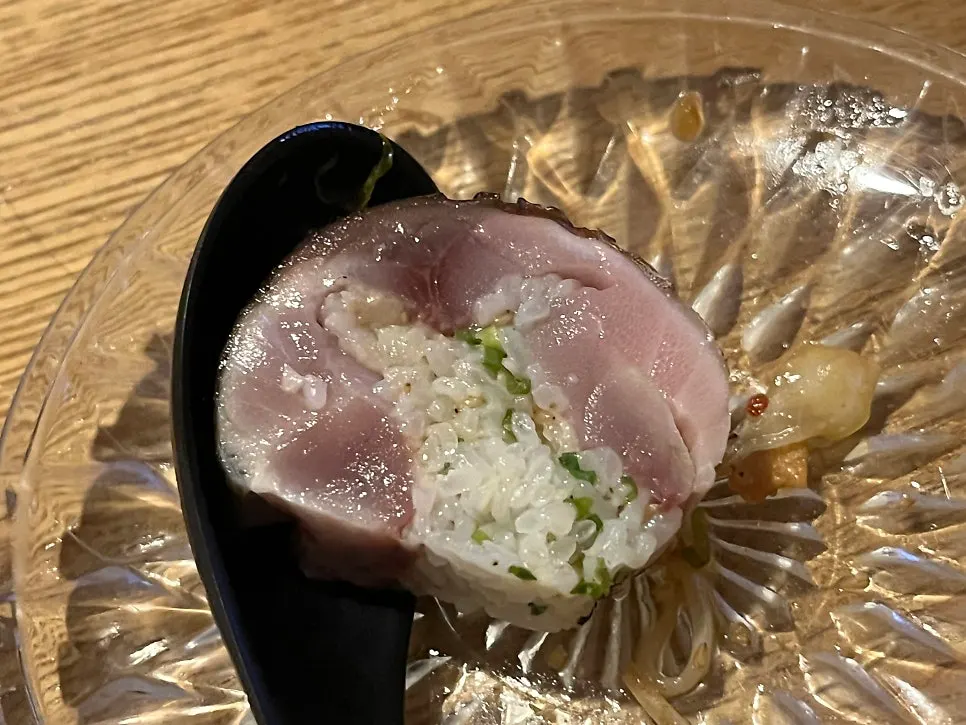 A piece of mackerel pressed sushi with wasabi
