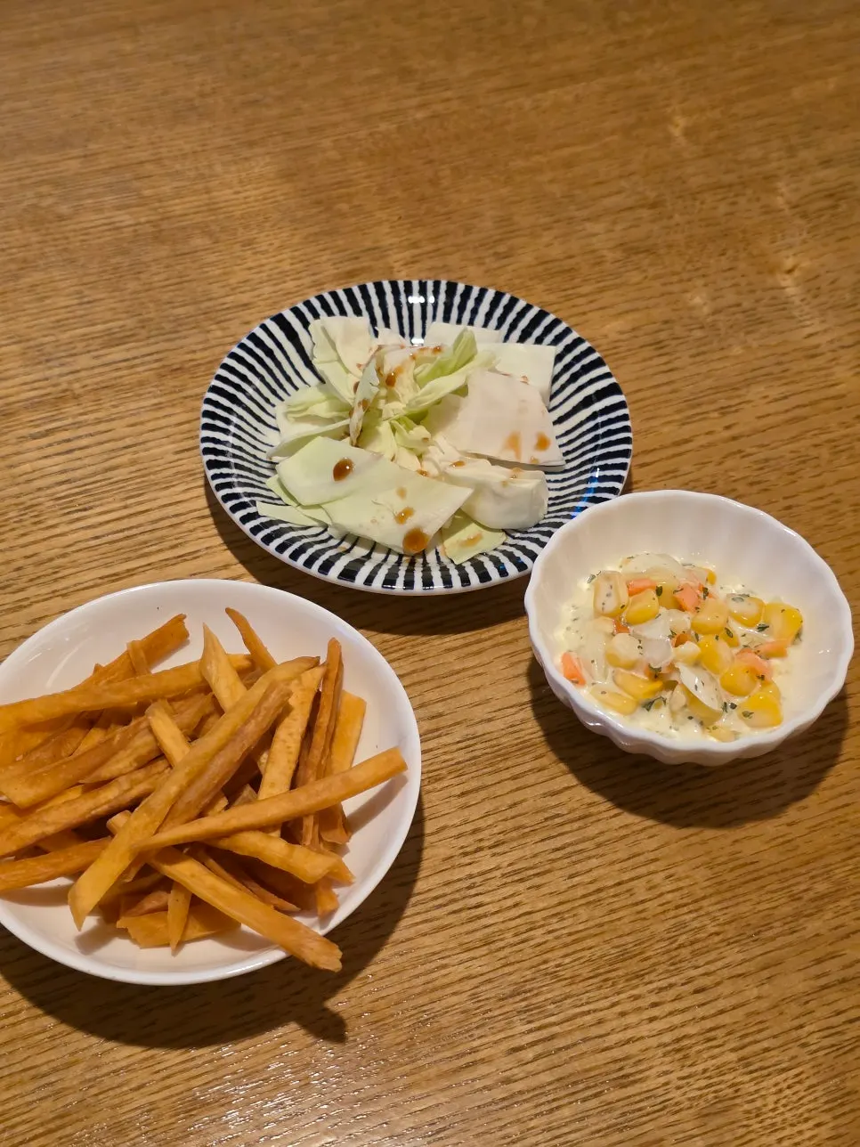 Basic side dishes of sweet potato sticks, corn salad and cabbage
