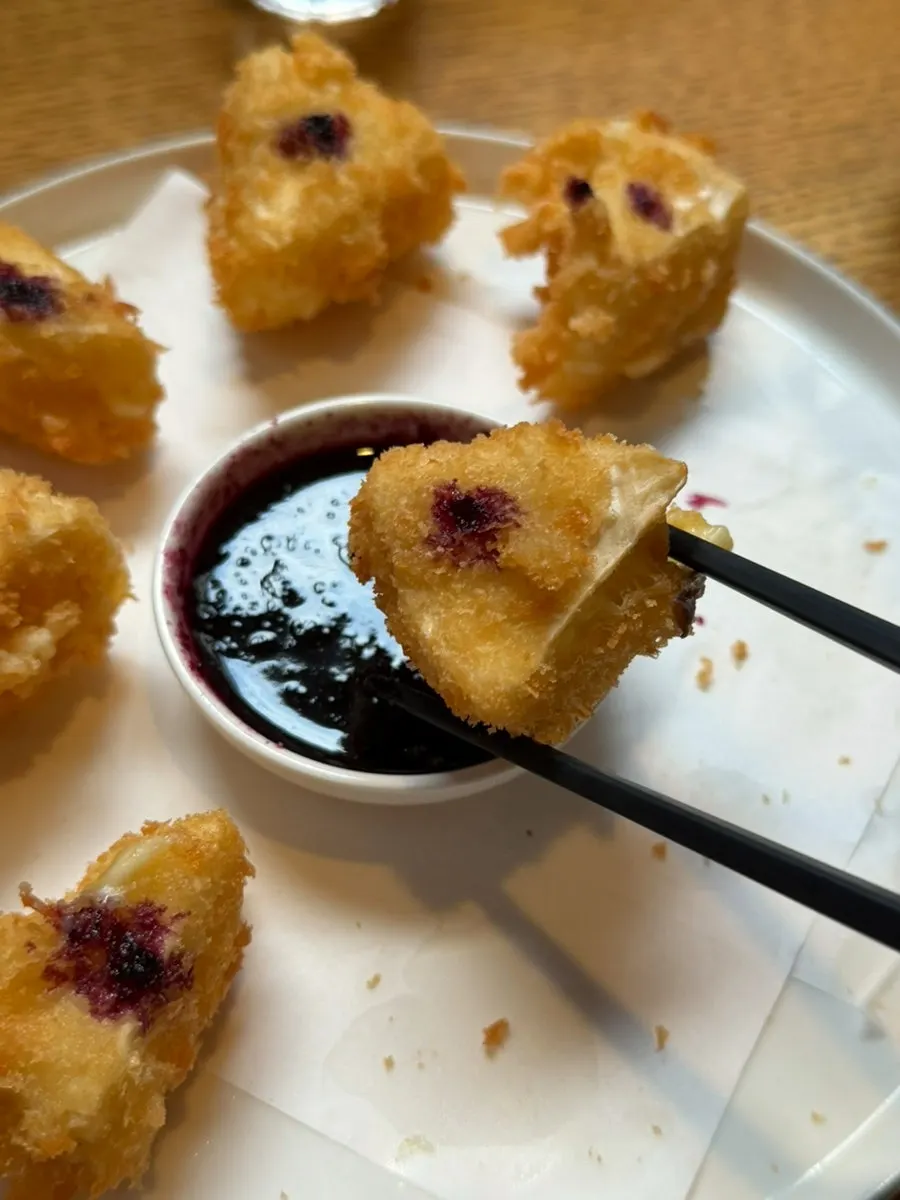 Cheese fritters served with blueberry sauce