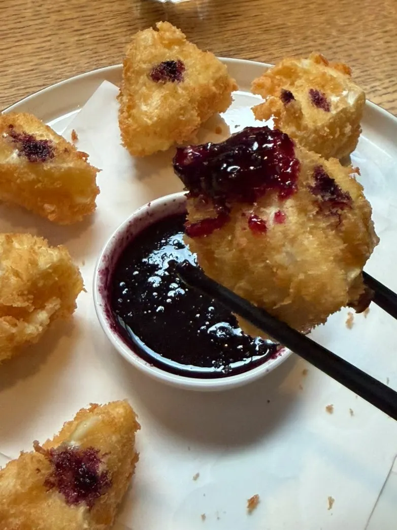 Cross-section of crispy camembert cheese fritter