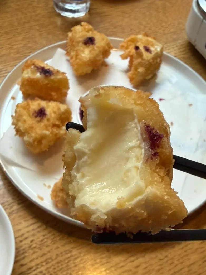 Cheese fritter stretching as it's pulled apart