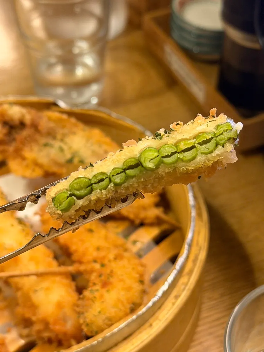 Sake cup and kushikatsu side dish spread