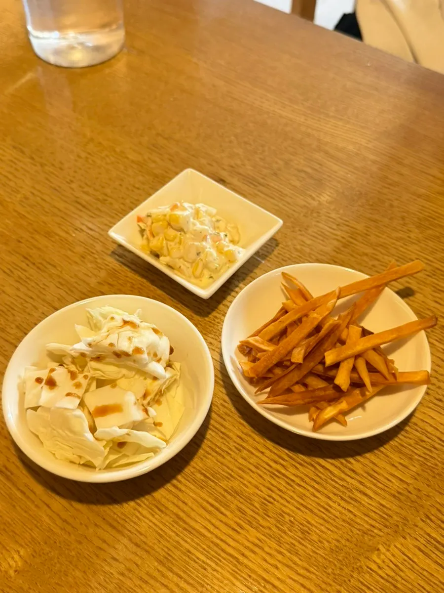 Basic side dishes of corn salad, cabbage and sweet potato chips