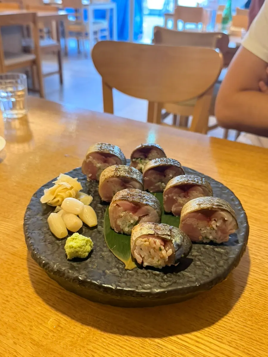 A plate of mackerel stick sushi with ginger